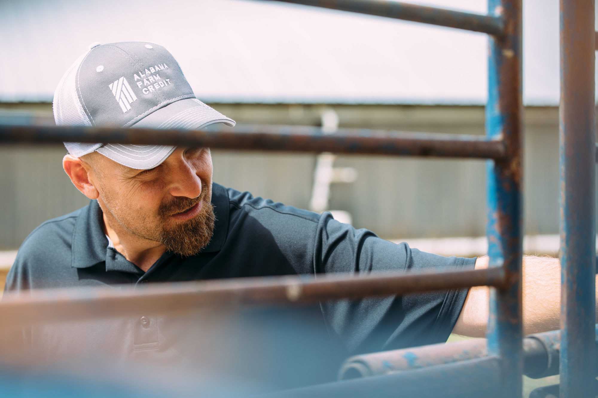 man wearing alabama farm credit hat