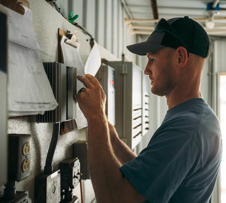 man looking at documents on clipboard