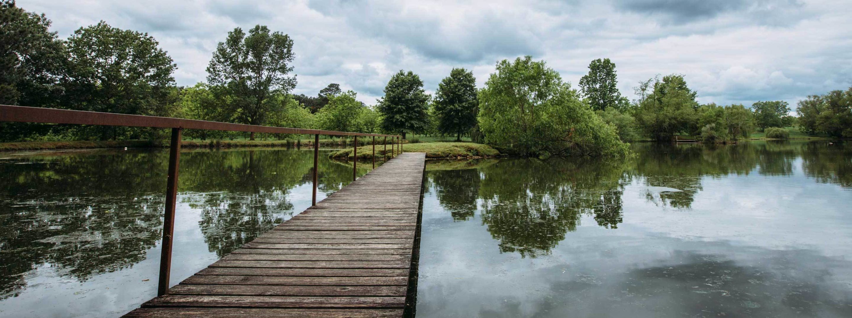 wooden walkway on pond