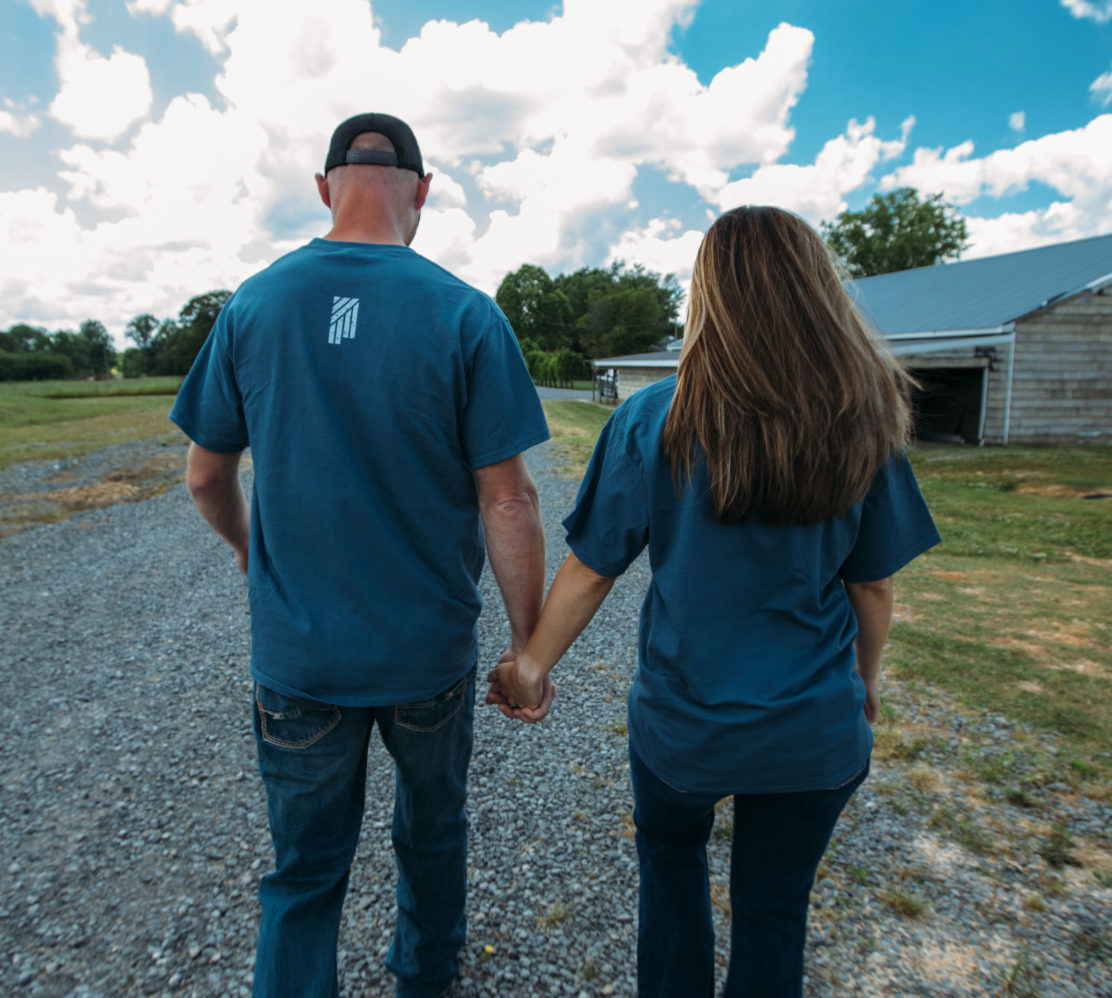 man and woman holding hands walking